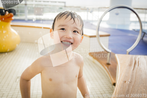 Image of Mixed Race Boy Having Fun at the Water Park