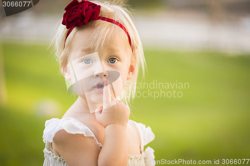 Image of Adorable Little Girl Wearing White Dress In A Grass Field