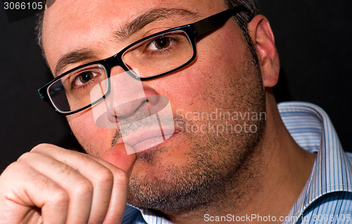 Image of Pensive bearded caucasian man wearing eyeglasss