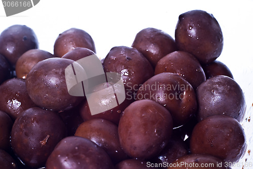 Image of Brown  olives in bowl isolated 