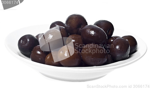 Image of Brown  olives in bowl isolated 