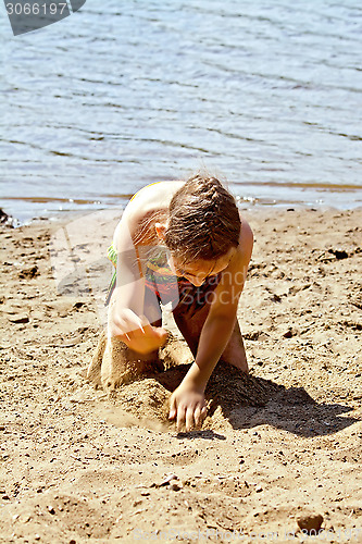 Image of Girl playing with sand