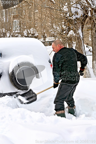Image of Man with a shovel in snow