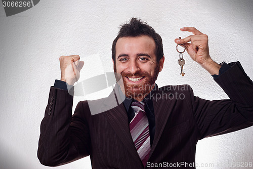 Image of Happy businessman holding a house key