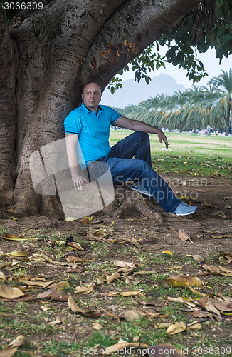 Image of Man poses outside in the park