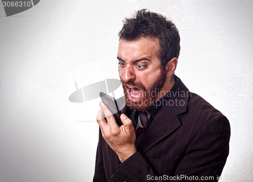 Image of Man in business suit shouting into his mobile phone