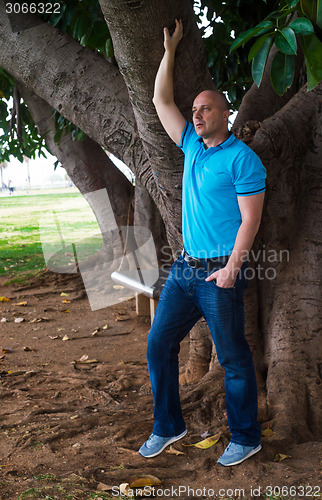 Image of Man poses outside in the park