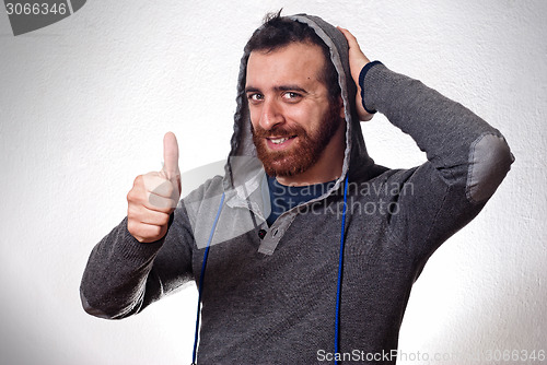 Image of happy young man showing thumb up sign