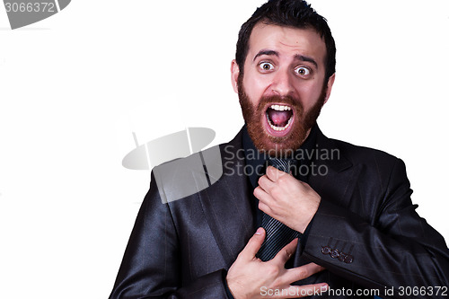 Image of business man grabbing his tie screaming.