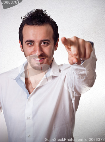 Image of young man pointing a finger towards you