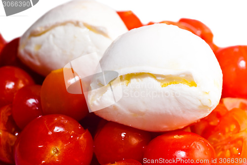 Image of Mozarella cheese on top of red tomatoes