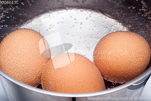 Image of eggs boiling in pan of water