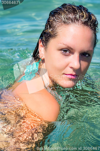 Image of Beautiful Woman Relaxing in turquoise Water