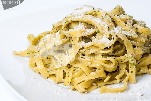 Image of pasta with pesto on white plate