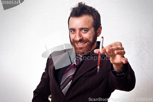 Image of happy businessman handing a pen to sign the contract