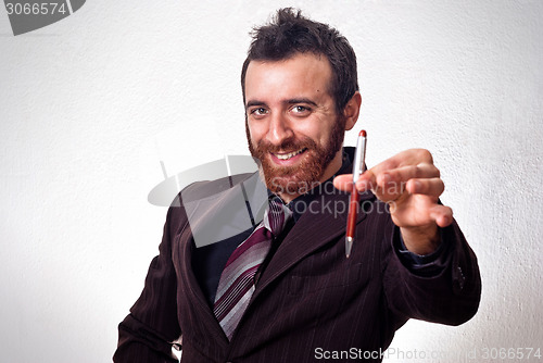 Image of happy businessman handing a pen to sign the contract