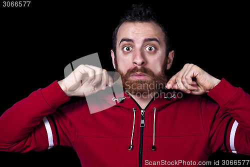 Image of young guy pulls his long red beard