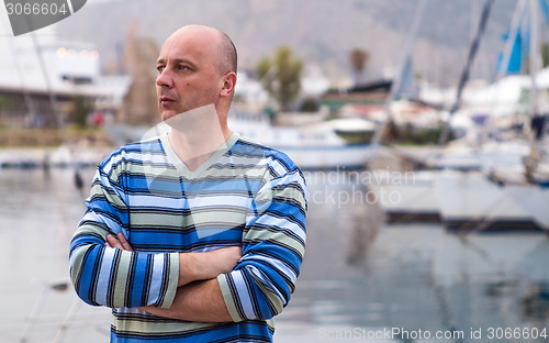 Image of Businessman standing by expensive sailing boats and yachts in a 