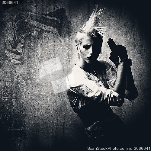 Image of acttractive blond girl with gun