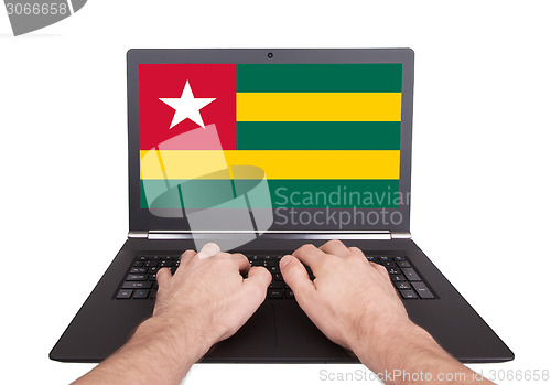 Image of Hands working on laptop, Togo