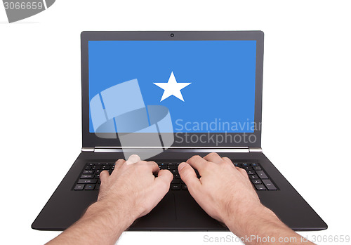 Image of Hands working on laptop, Somalia