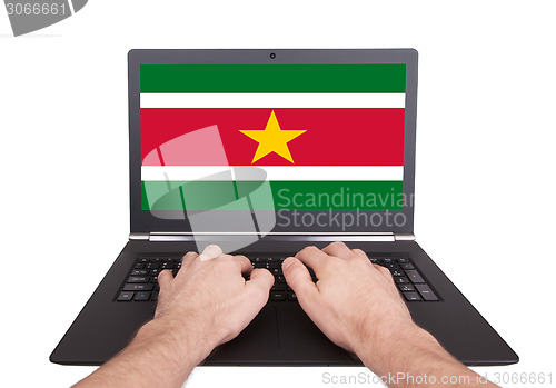 Image of Hands working on laptop, Suriname