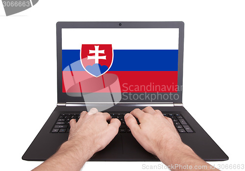 Image of Hands working on laptop, Slovakia