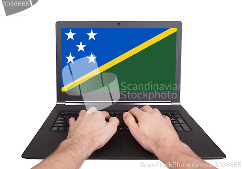 Image of Hands working on laptop, Solomon Islands