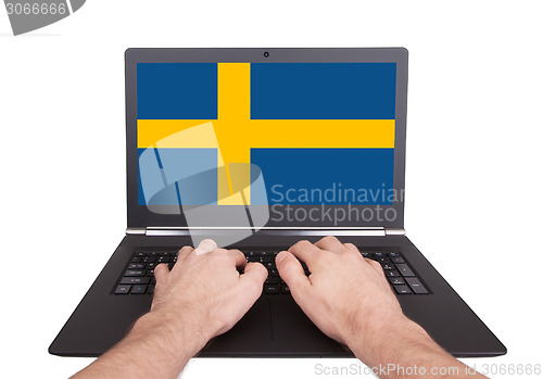 Image of Hands working on laptop, Sweden