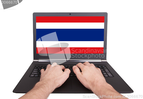 Image of Hands working on laptop, Thailand