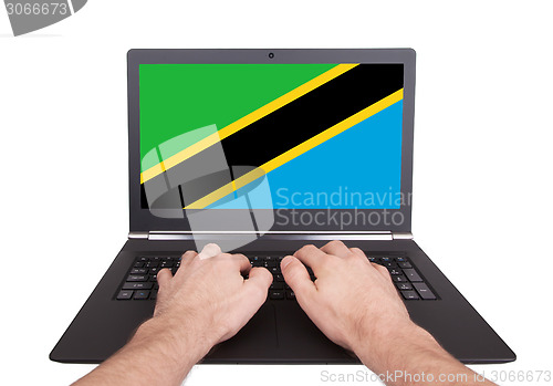 Image of Hands working on laptop, Tanzania