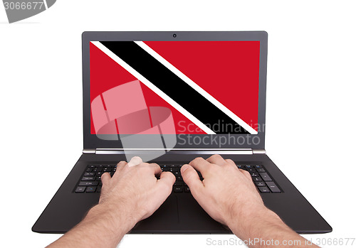 Image of Hands working on laptop, Trinidad and Tobago