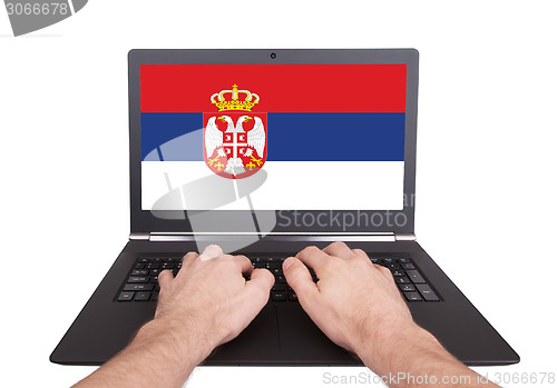 Image of Hands working on laptop, Serbia