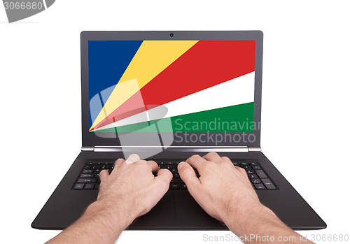 Image of Hands working on laptop, Seychelles