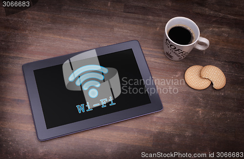 Image of Tablet with Wi-Fi connection on a wooden desk