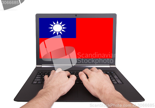 Image of Hands working on laptop, Taiwan