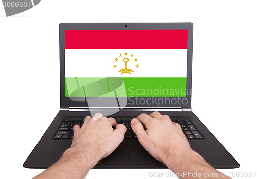 Image of Hands working on laptop, Tajikistan