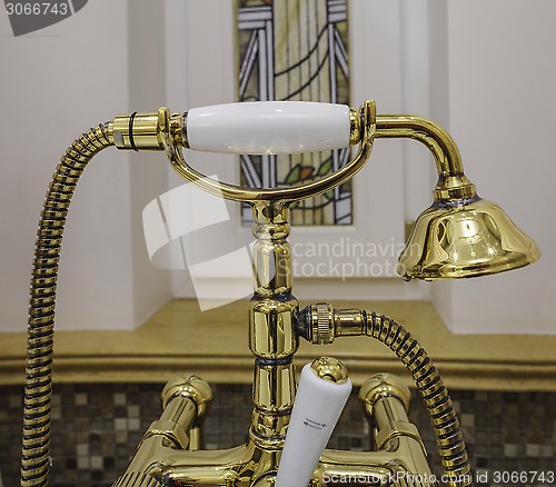 Image of gold bathtub faucets and shower head