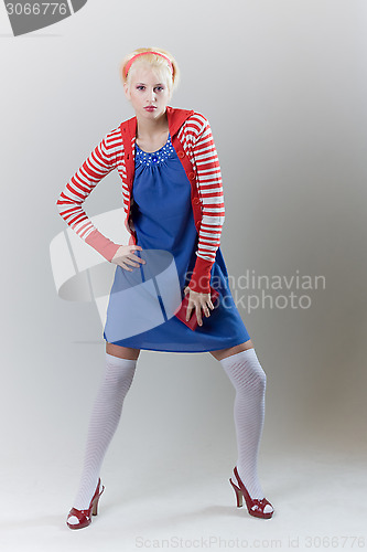 Image of emotion pose blond girl in red woolly