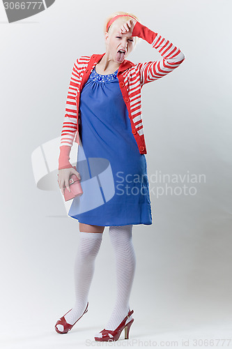 Image of emotion pose blond girl in red woolly