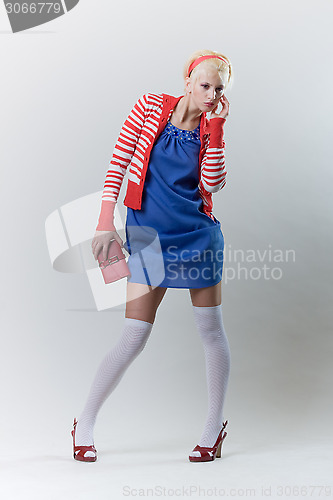 Image of emotion pose blond girl in red woolly