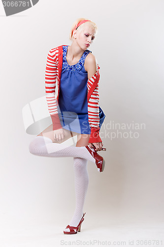 Image of emotion pose blond girl in red woolly