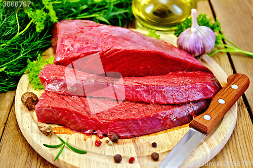 Image of Meat beef on board with herbs and spices