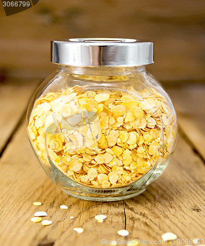Image of Pea flakes in jar on board