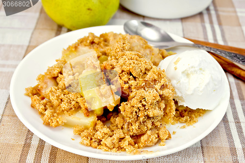 Image of Crumble with pears in plate on tablecloth