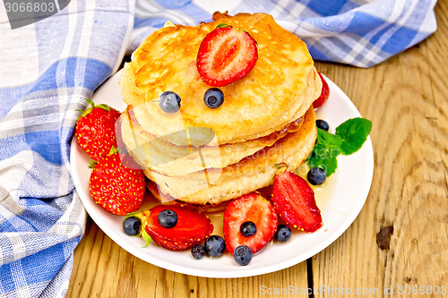 Image of Flapjacks with strawberries and blueberries on board