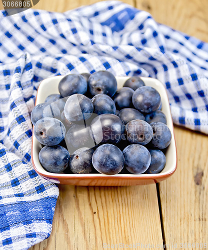 Image of Plum blue in bowl on board with napkin