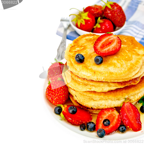 Image of Flapjacks with strawberries and blueberries in bowl with napkin