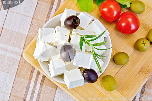 Image of Feta with olives in bowl on fabric