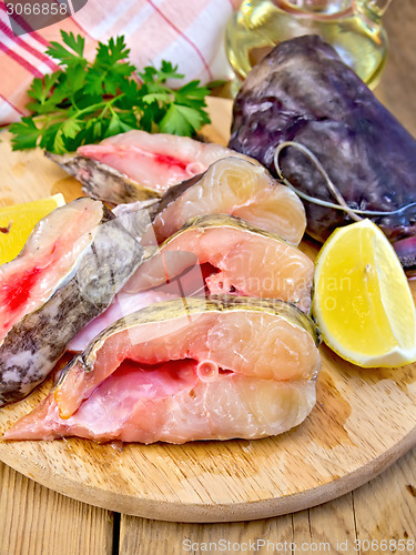 Image of Catfish raw with lemon on board